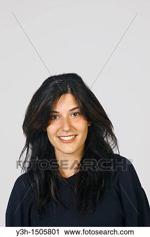 Stock Image - Studio shot of young girl, smiling. Fotosearch