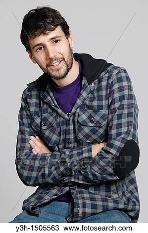 Studio shot of young man, arms crossed View Large Photo Image Stock Image - Studio shot of young man, arms crossed. Fotosearch