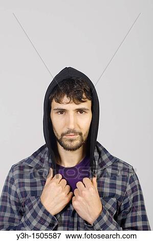 Studio shot of young man, hooded jacket View Large Photo Image Stock Photo - Studio shot of young man, hooded jacket. Fotosearch