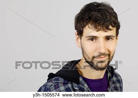 Studio shot of young man, looking at camera View Large Photo Image Picture - Studio shot of young man, looking at camera. Fotosearch
