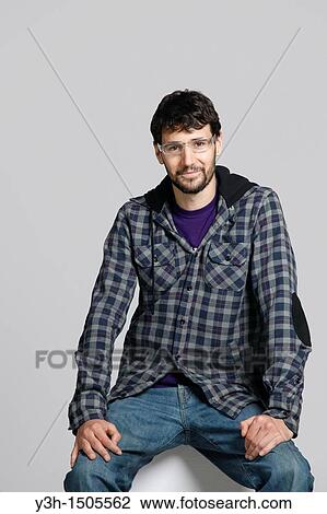 Studio shot of young man, looking at camera View Large Photo Image Stock Image - Studio shot of young man, looking at camera. Fotosearch