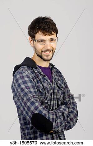 Studio shot of young man, looking at camera View Large Photo Image Stock Image - Studio shot of young man, looking at camera. Fotosearch