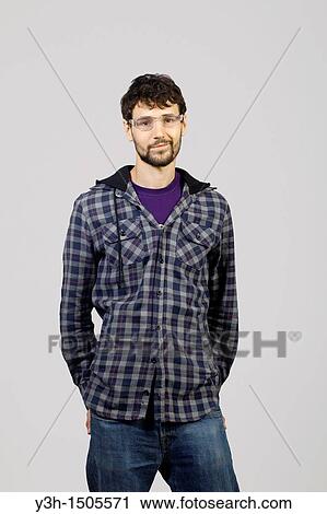 Studio shot of young man, looking at camera View Large Photo Image Stock Image - Studio shot of young man, looking at camera. Fotosearch