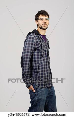 Stock Image - Studio shot of young man, looking at camera. Fotosearch