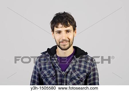 Studio shot of young man, looking at camera View Large Photo Image Stock Image - Studio shot of young man, looking at camera. Fotosearch