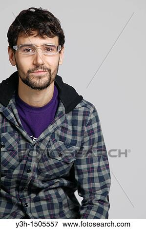 Stock Photo - Studio shot of young man, looking at camera. Fotosearch