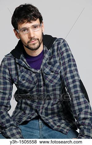 Stock Photo - Studio shot of young man, looking at camera. Fotosearch