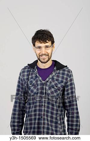 Stock Photo - Studio shot of young man, looking at camera. Fotosearch