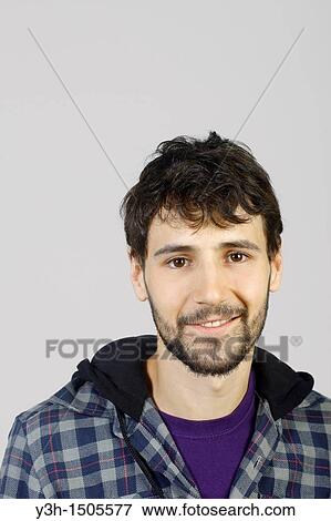 Studio shot of young man, looking at camera View Large Photo Image Stock Photo - Studio shot of young man, looking at camera. Fotosearch