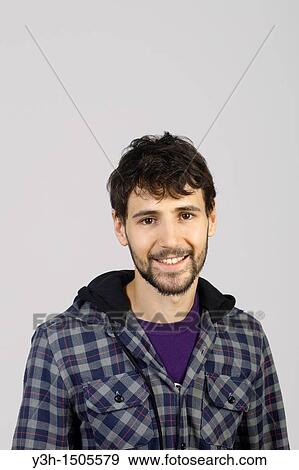 Studio shot of young man, looking at camera View Large Photo Image Stock Photo - Studio shot of young man, looking at camera. Fotosearch