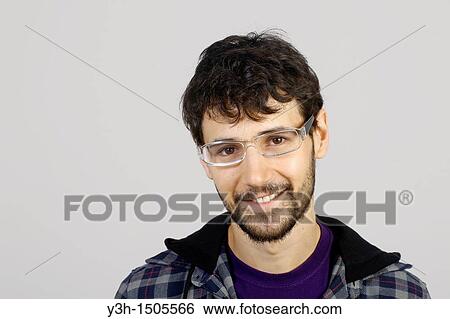 Studio shot of young man, looking at camera View Large Photo Image Stock Photograph - Studio shot of young man, looking at camera. Fotosearch