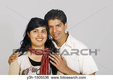 Stock Photograph - Studio shot of young pakistani couple. Fotosearch