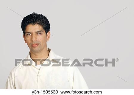 Stock Image - Studio shot of young pakistani man. Fotosearch