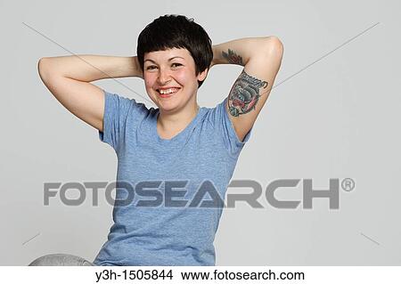 Studio shot of young tattooed woman View Large Photo Image Picture - Studio shot of young tattooed woman. Fotosearch
