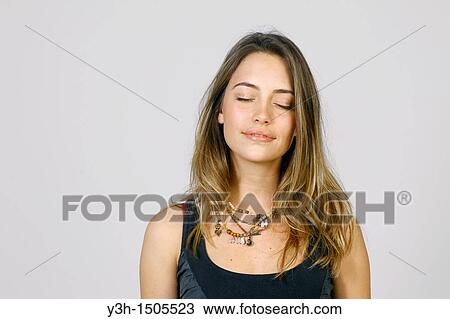 Studio shot of young woman, closed eyes View Large Photo Image Stock Image - Studio shot of young woman, closed eyes. Fotosearch
