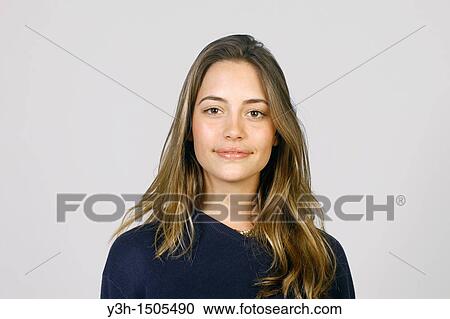 Stock Image - Studio shot of young woman, looking at camera. Fotosearch
