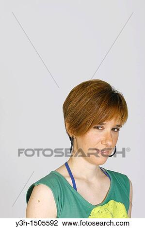 Studio shot of young woman, looking at camera View Large Photo Image Stock Image - Studio shot of young woman, looking at camera. Fotosearch