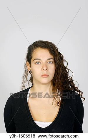 Stock Photo - Studio shot of young woman, looking at camera. Fotosearch
