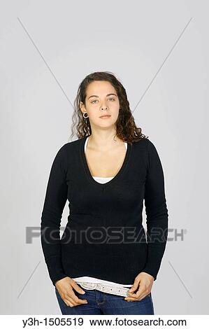Studio shot of young woman, looking at camera View Large Photo Image Stock Photo - Studio shot of young woman, looking at camera. Fotosearch