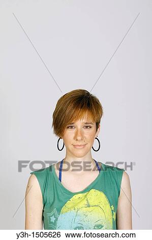 Stock Photograph - Studio shot of young woman, looking at camera. Fotosearch