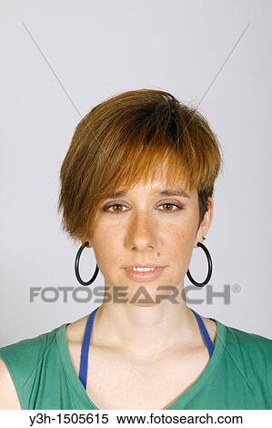 Stock Photography - Studio shot of young woman, looking at camera. Fotosearch