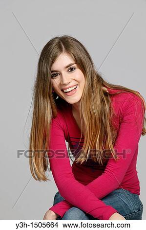 Picture - Studio shot of young woman, smiling. Fotosearch