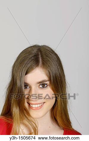 Picture - Studio shot of young woman, smiling. Fotosearch