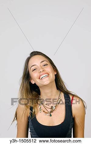 Studio shot of young woman, smiling View Large Photo Image Stock Image - Studio shot of young woman, smiling. Fotosearch