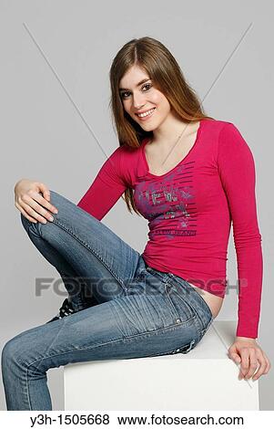 Studio shot of young woman, smiling View Large Photo Image Stock Photo - Studio shot of young woman, smiling. Fotosearch