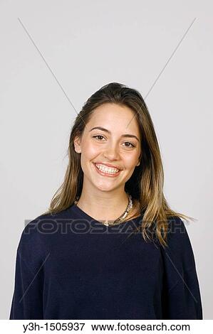 Stock Photo - Studio shot of young woman, smiling. Fotosearch