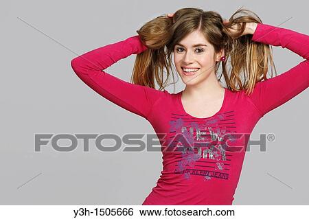 Studio shot of young woman, smiling View Large Photo Image Stock Photograph - Studio shot of young woman, smiling. Fotosearch