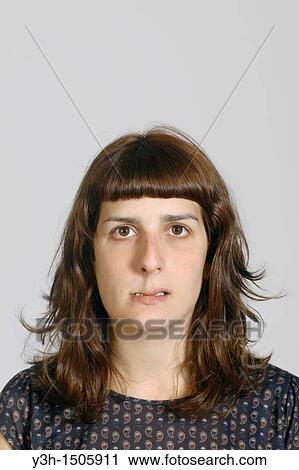 Stock Image - Studio shot of young woman. Fotosearch