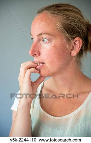 Studio Tuinstraat, Tilburg, Netherlands. Studio-portrait of a young, blonde woman, looking away, with her hand touching her lips. View Large Photo Image Stock Image - Studio Tuinstraat, Tilburg, Netherlands. Studio-portrait of a young, blonde woman, looking away, with her hand touching her lips.. Fotosearch