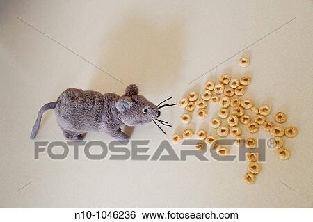 Stock Photograph - Stuffed toy mouse next to some spilled breakfast cereal. Fotosearch