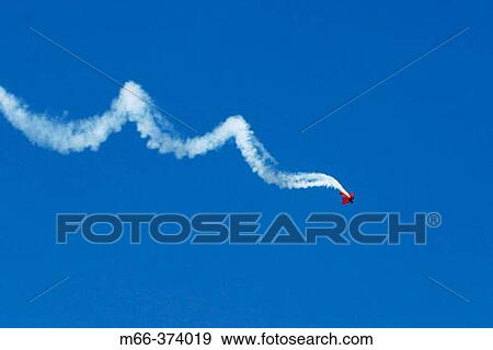 Stock Photo - Stunt plane spiraling across the deep blue sky in an air show. Fotosearch
