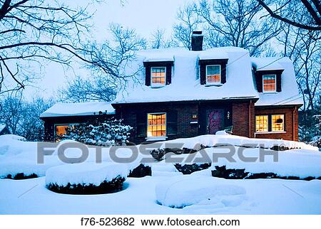 Stock Image - Suburban home at dusk immediately after snowstorm. Boston. Massachusetts. USA. Fotosearch