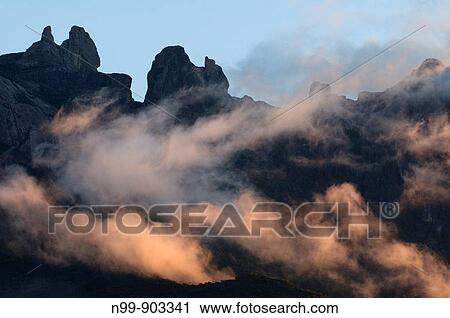 Summits of Mount Kinabalu and clouds at sunrise Mount Kinabalu National Park Sabah Borneo Malaysia View Large Photo Image Stock Image - Summits of Mount Kinabalu and clouds at sunrise Mount Kinabalu National Park Sabah Borneo Malaysia. Fotosearch