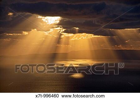 Sun bursting through clouds on the gulf of Messinia near Langada in the Outer Mani, southern Peloponnese, Greece View Large Photo Image Stock Image - Sun bursting through clouds on the gulf of Messinia near Langada in the Outer Mani, southern Peloponnese, Greece. Fotosearch