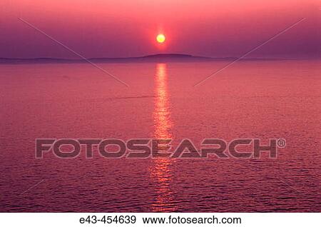 Sun rising over a lake with mist - orange and red in colors View Large Photo Image Stock Photo - Sun rising over a lake with mist - orange and red in colors. Fotosearch