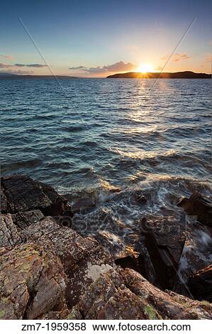 Sun setting behind Horse Island near the Summer Isles in the Highlands of Scotland. View Large Photo Image Stock Photo - Sun setting behind Horse Island near the Summer Isles in the Highlands of Scotland.. Fotosearch