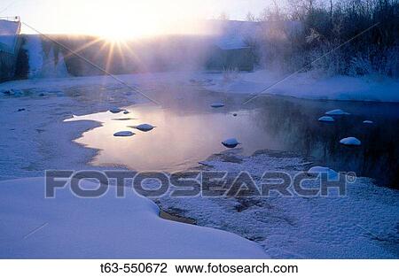 Sun setting over frozen lake. Manitoba, Canada. View Large Photo Image Stock Image - Sun setting over frozen lake. Manitoba, Canada.. Fotosearch