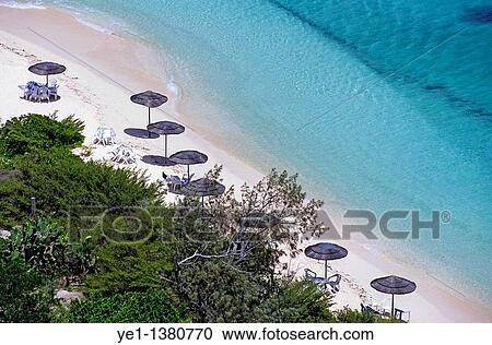 Sun umbrellas dotted along the white sand beach on Amedee Island, New Caledonia View Large Photo Image Stock Image - Sun umbrellas dotted along the white sand beach on Amedee Island, New Caledonia. Fotosearch