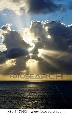 Sunbeams bursting through cloud at sunset over the Bristol Channel near Ilfracombe, Devon, England, United Kingdom View Large Photo Image Picture - Sunbeams bursting through cloud at sunset over the Bristol Channel near Ilfracombe, Devon, England, United Kingdom. Fotosearch