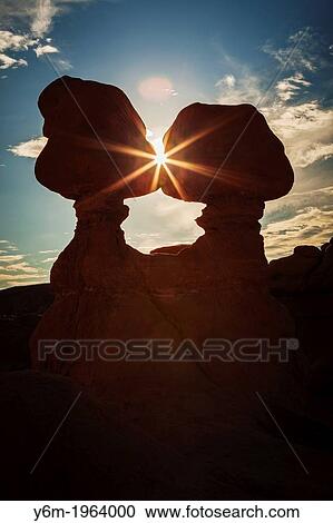 Stock Image - Sunburst through Hoodoos, Goblin Valley State Park, Utah.. Fotosearch