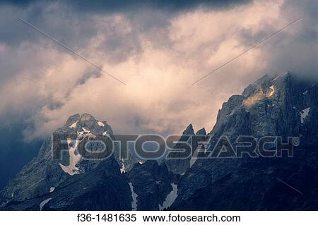 Sunlight on storm clouds near the summit of the Grand Tetons, Grand Teton Nat? l Pk, WYOMING View Large Photo Image Stock Photography - Sunlight on storm clouds near the summit of the Grand Tetons, Grand Teton Nat? l Pk, WYOMING. Fotosearch