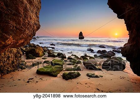 Stock Photo - Sunrise at Algarve rocky coast near Lagos, Algarve, Portugal.. Fotosearch