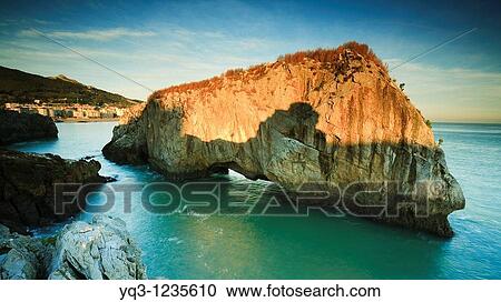 Stock Image - Sunrise at Isla de los Conejos, Castro Urdiales, Cantabria, Spain. Fotosearch