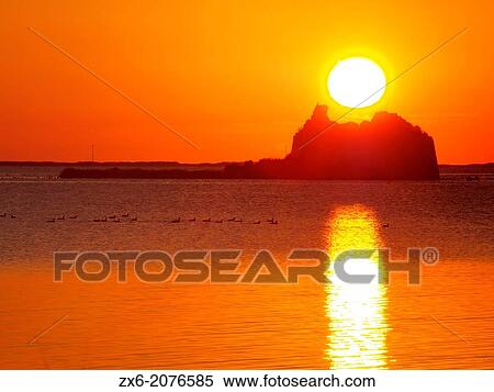 Sunrise behind St. John's Tower ruins at Alfacs Bay. Ebro River Delta Natural Park, Tarragona province, Catalonia, Spain. View Large Photo Image Stock Photography - Sunrise behind St. John's Tower ruins at Alfacs Bay. Ebro River Delta Natural Park, Tarragona province, Catalonia, Spain.. Fotosearch
