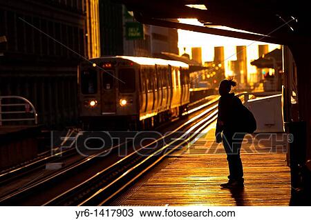 Stock Image - Sunrise illuminates the elevated tracks of the Chicago rapid transit system known as the? L? in Chicago, IL, USA. Fotosearch