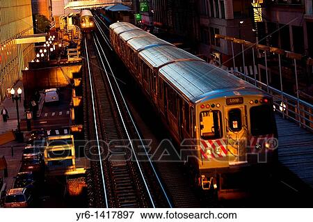 Sunrise illuminates the elevated tracks of the Chicago rapid transit system known as the? L? in Chicago, IL, USA View Large Photo Image Stock Photo - Sunrise illuminates the elevated tracks of the Chicago rapid transit system known as the? L? in Chicago, IL, USA. Fotosearch